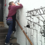 Roger Mason painting mural in Dalston
